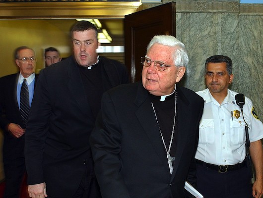 Catholic priests exiting a courtroom