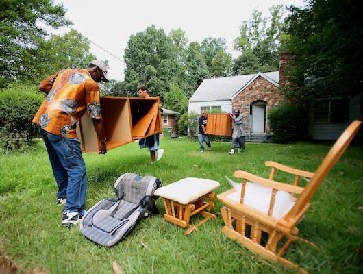 Photo of men removing furniture from a home