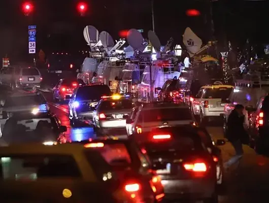 News trucks crowd the street in the once-sleepy town of Newtown, Connecticut.