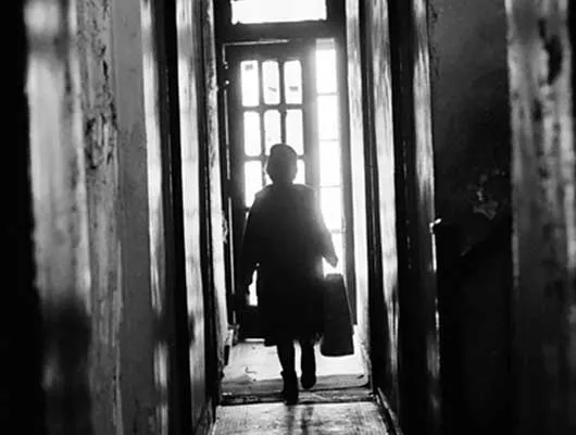 Woman walking in dark hallway