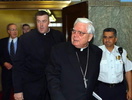 Catholic priests exiting a courtroom
