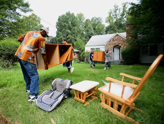 Photo of men removing furniture from a home