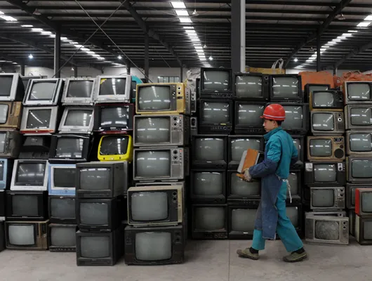 televisions stacked up to be recycled