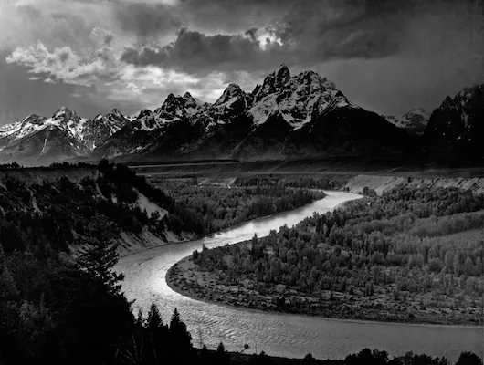The Tetons and the Snake River, a black and white photograph taken by Ansel Adams in 1942, at the Grand Teton National Park, in Wyoming.