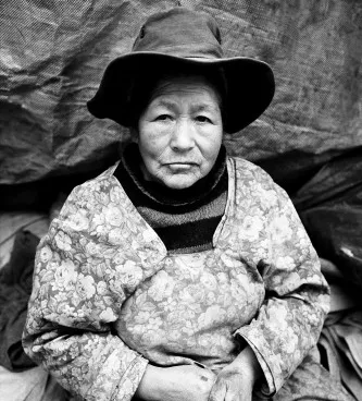 Widow of the Mines Potosi, Bolivia. A widow spends her day sifting through spent rock for bits of silver by which to feed her family.